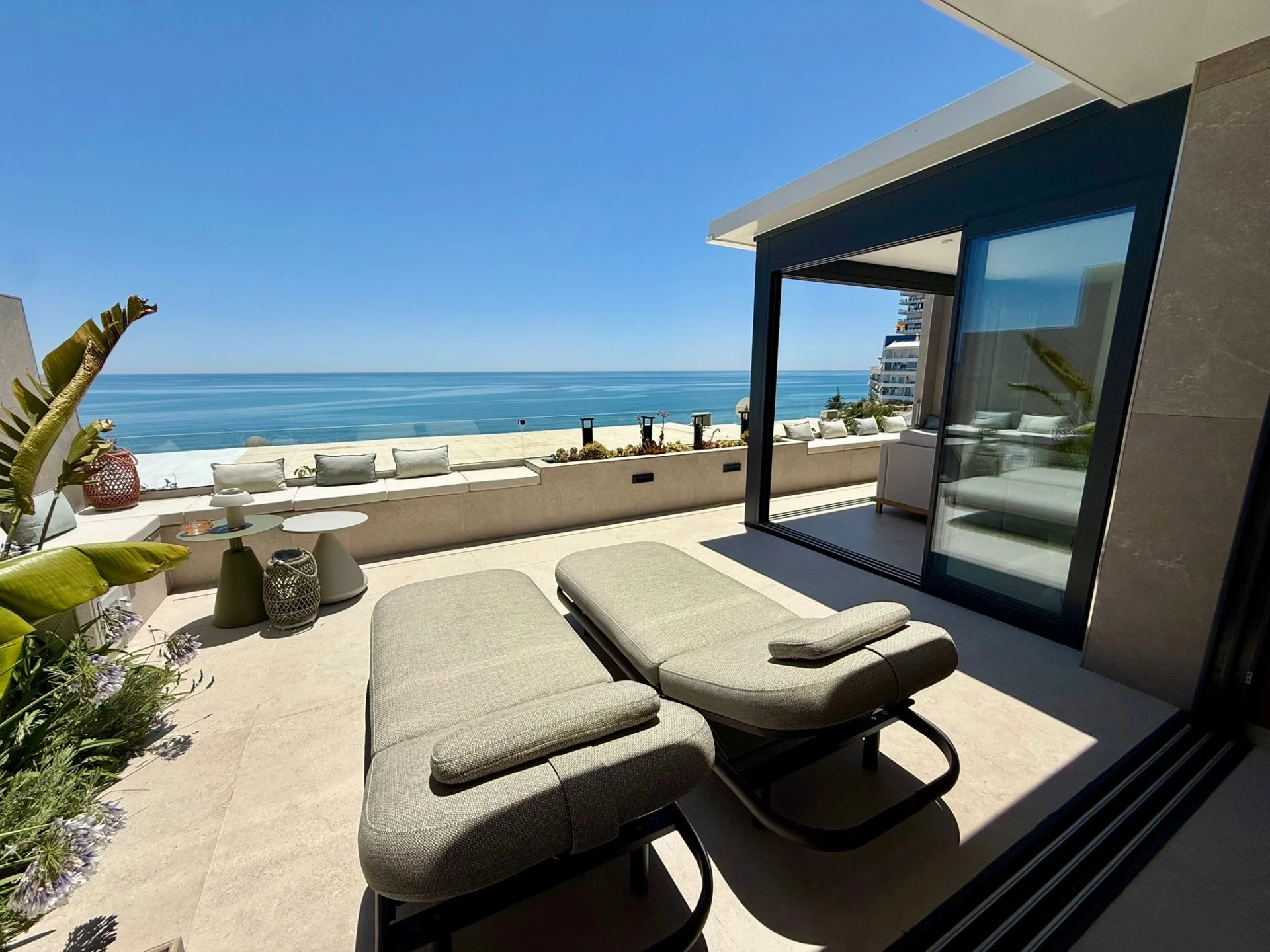 El Castillito terrace with sun loungers and a wide sea view